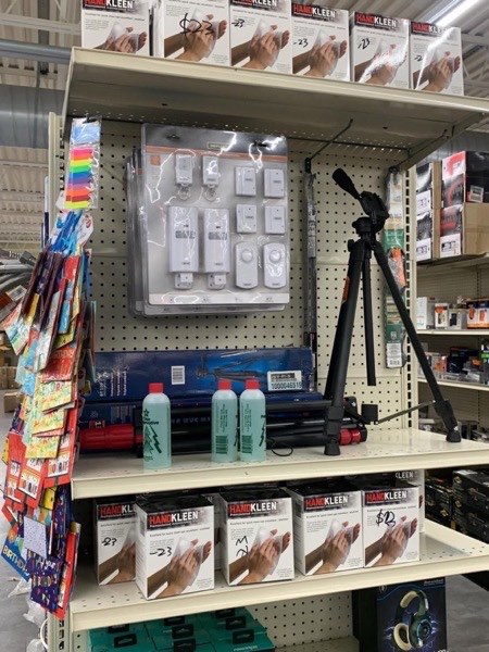 Power tools and tripod on hardware shelves